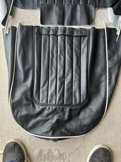 TR4A pair of black with white piping leather seat covers with foam & backboards