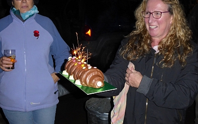 Jan brings out the 'Colin the Caterpillar' cake for Jill West's birthday
