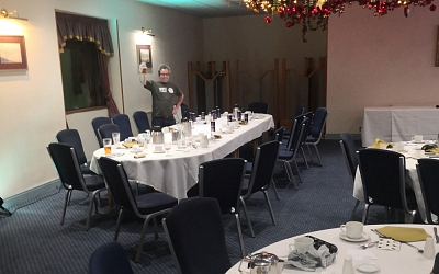 Is he going to clear the tables or is he waiting more food and drink?