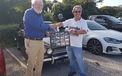 Pete Rugg presents Rodney with a photo montage of all of his TRs.